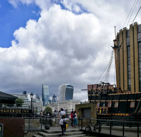 Thameside Inn with the Golden Hinde replica ship and City skyscrapers behind