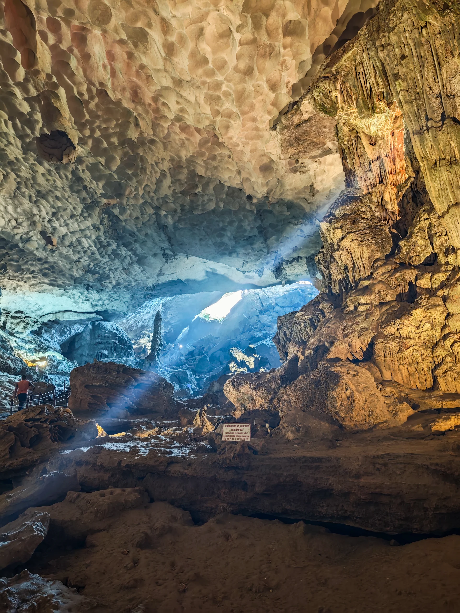 Ha Long Bay horizon with layered karst silhouettes fading into the distance over calm green water