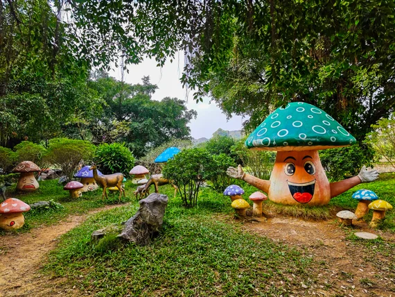 Colorful mushroom sculptures in a small park area near Hang Mua entrance